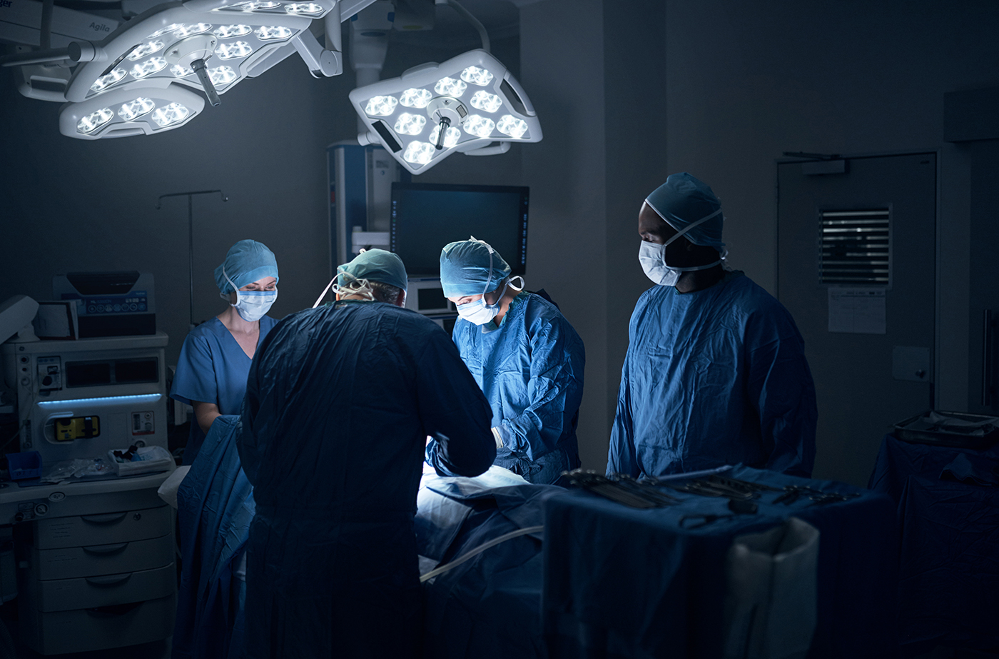 Surgical team performing procedure in operating theatre