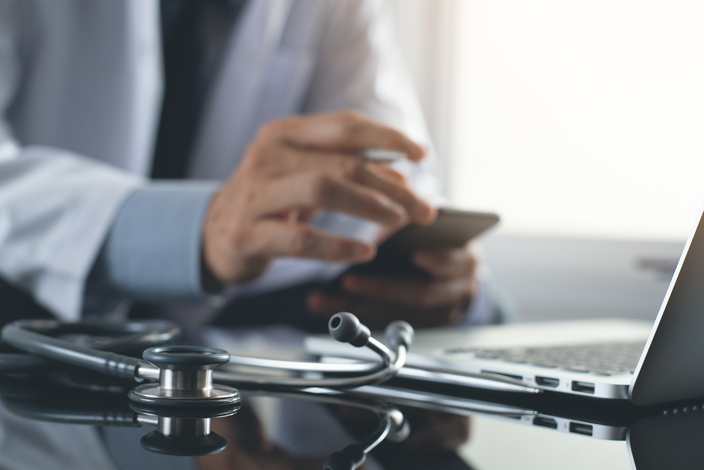 Doctor with stethoscope and laptop